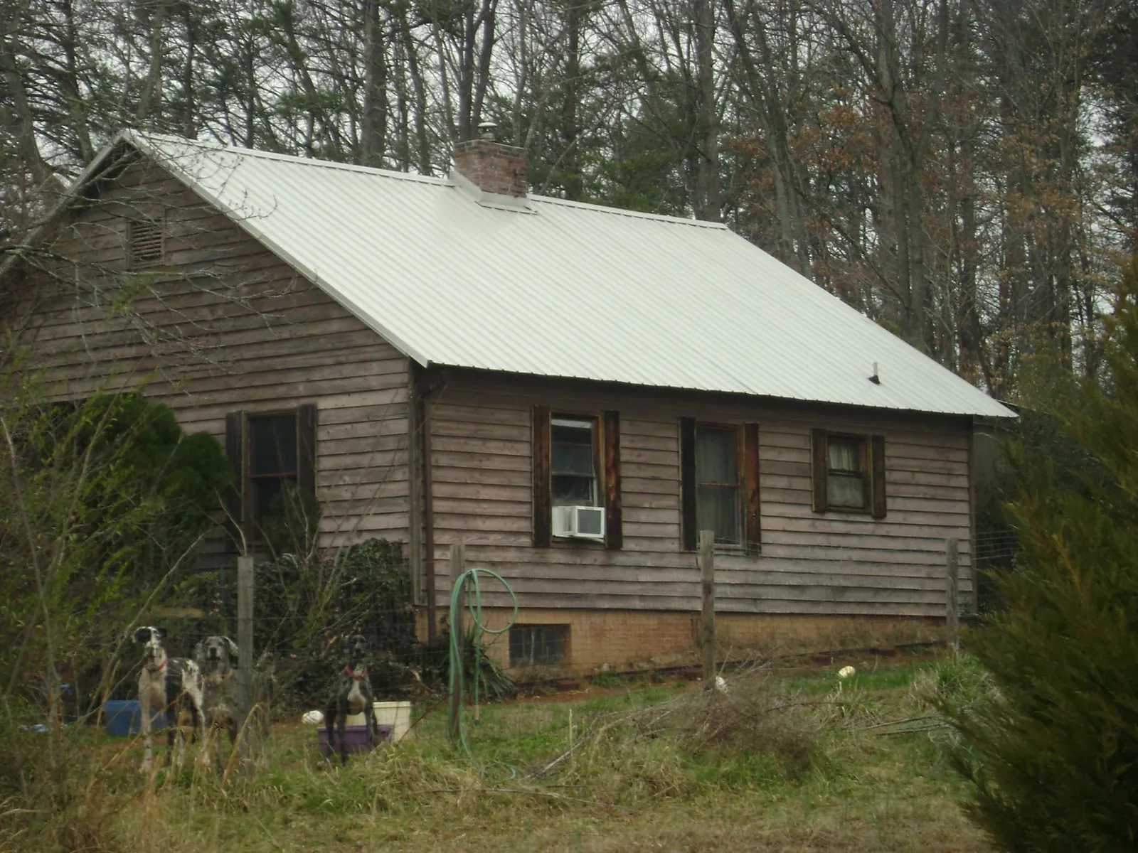 White metal roof on an old wood sided farmhouse in Cokeburg